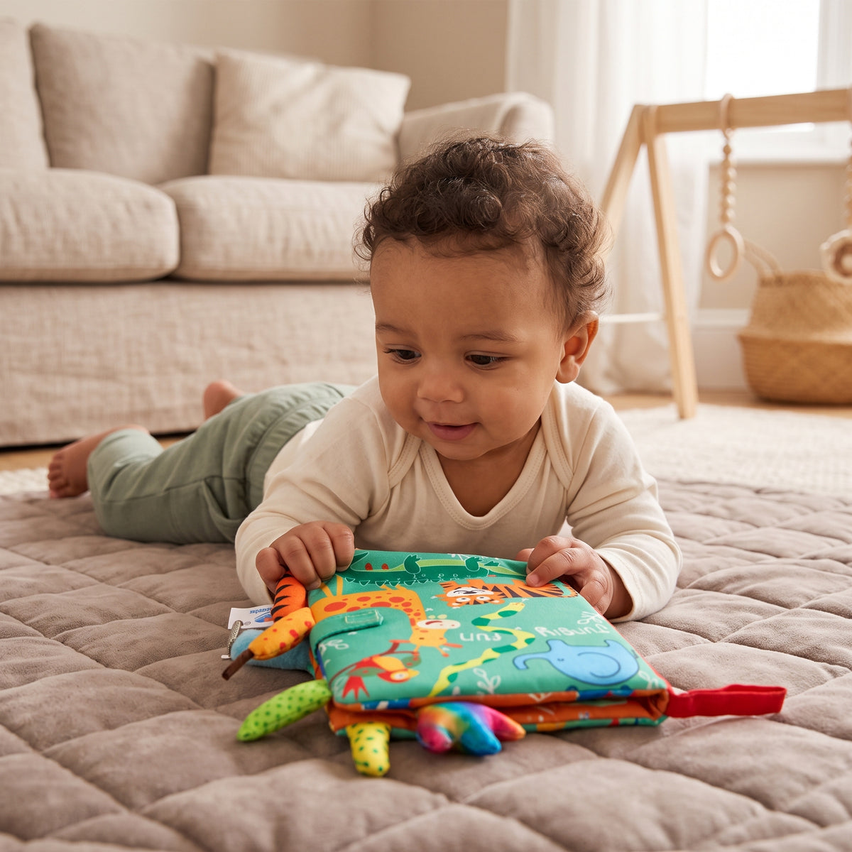 Baby exploring the Momi Toys Soft Cloth Book, Jungle