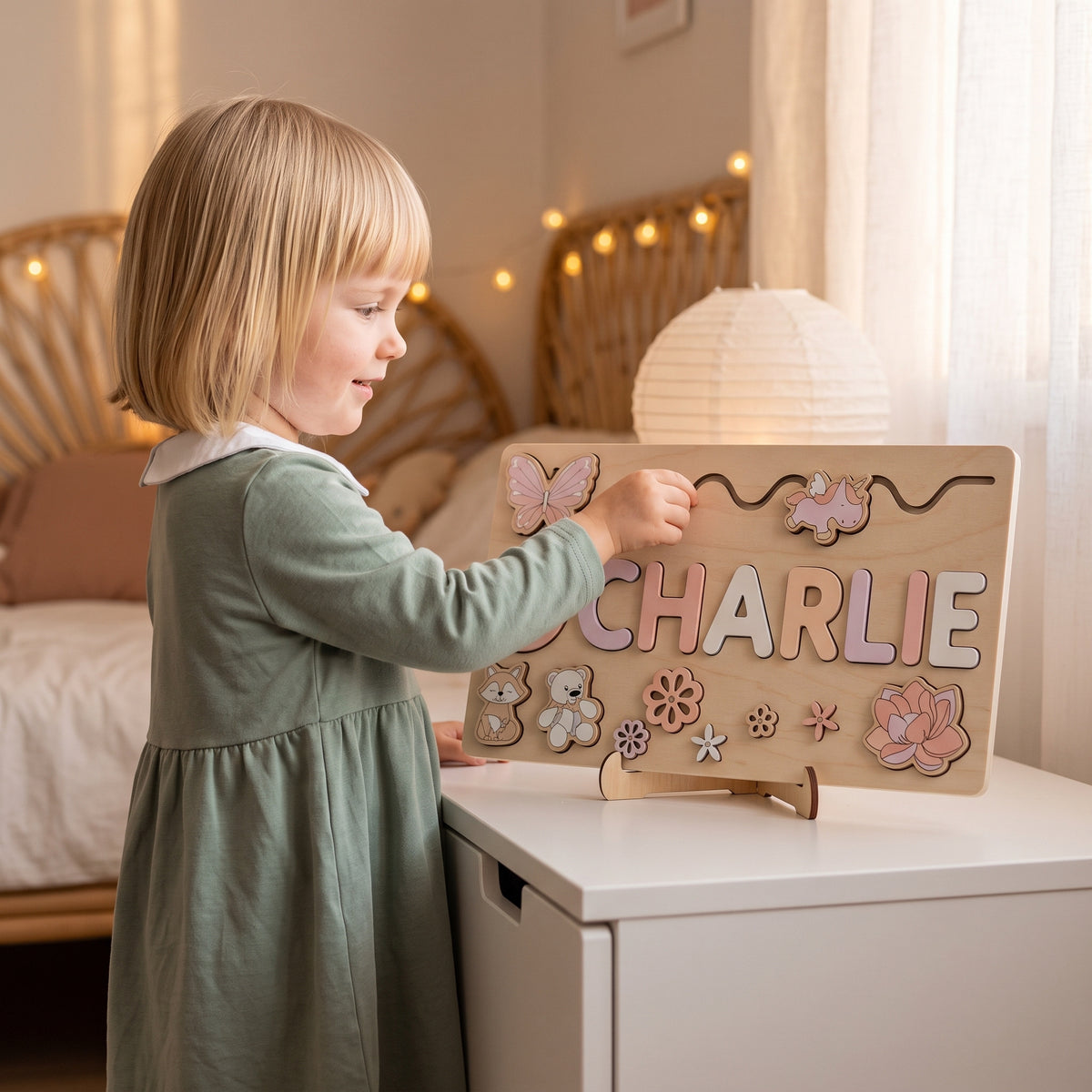 Girl playing with the Momi Toys Personalized Wooden Name Puzzle, Pink Blossom design