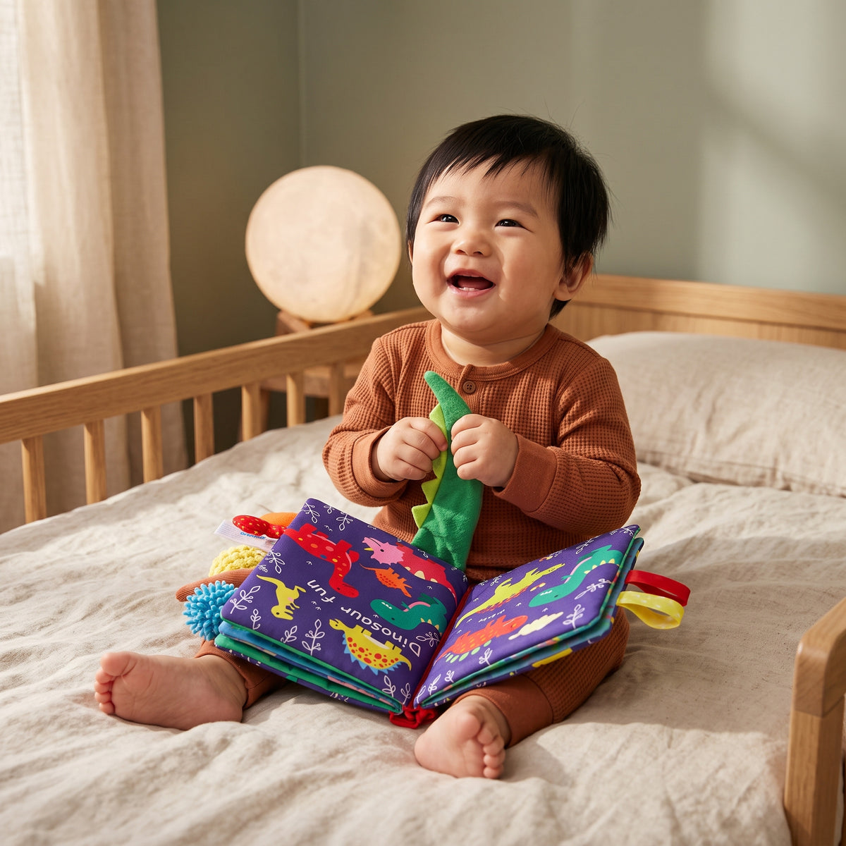Baby with the Momi Toys Soft Cloth Book, Dinosaurs