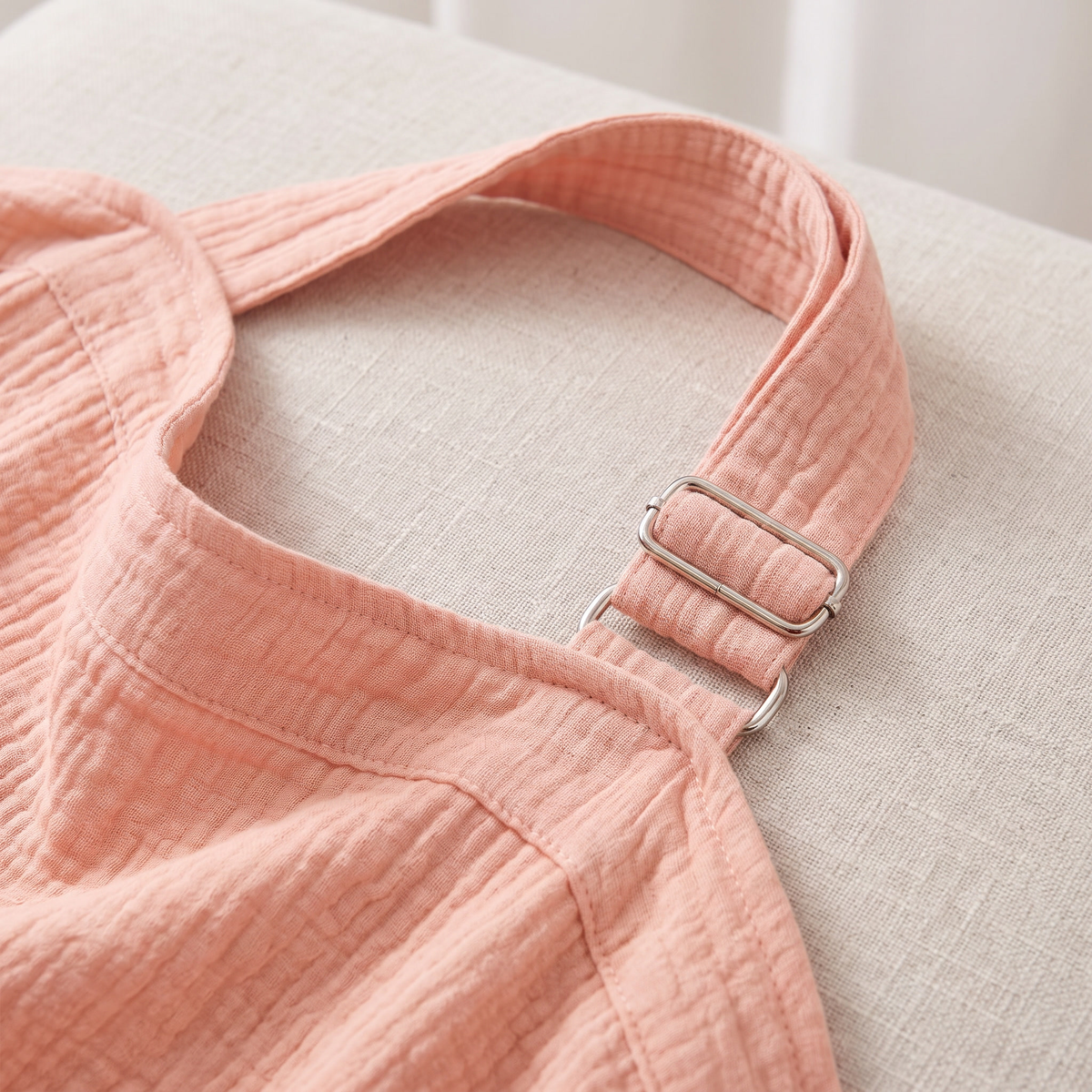 Close up of woven cotton nursing cover and metal D ring strap