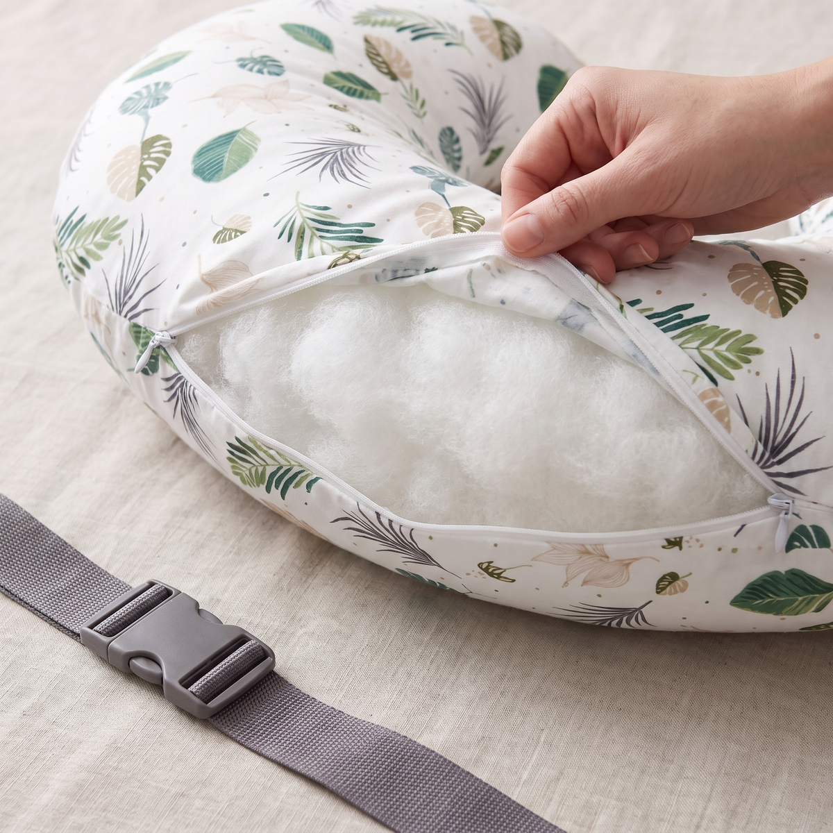 Hand unzipping removable cotton cover on cradle nursing pillow