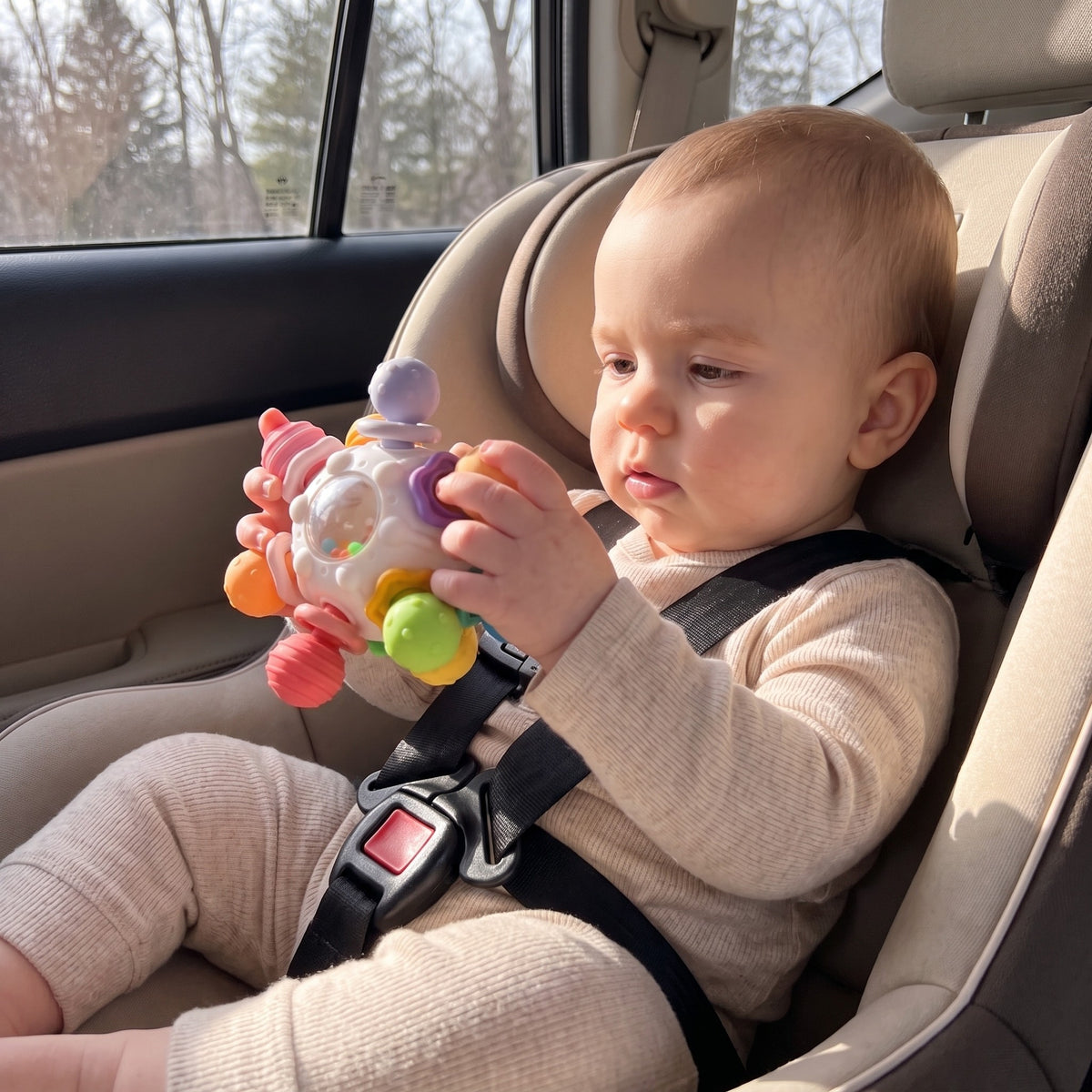 momi-09-3 baby holding teether in car seat