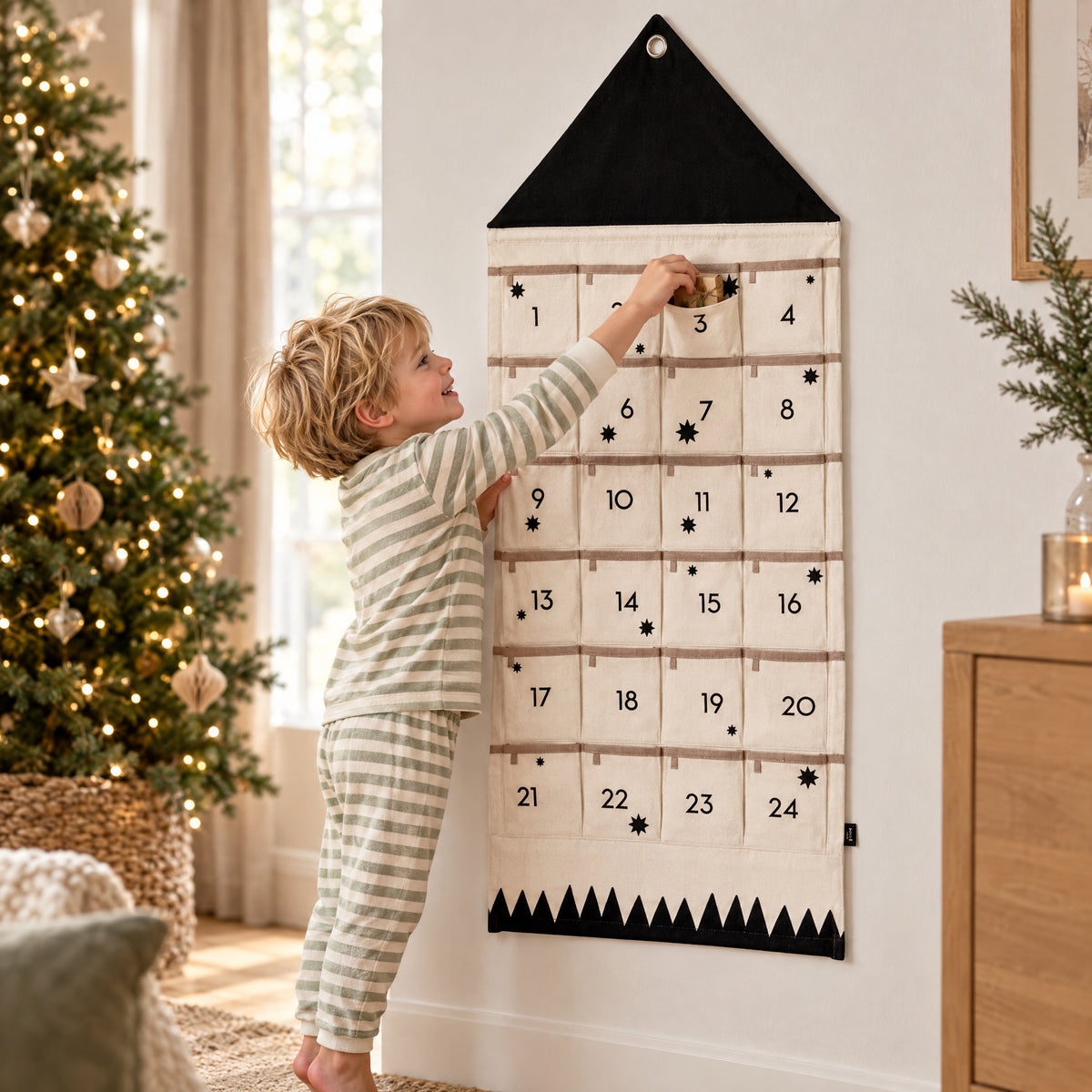 Child playing with the Momi Toys fabric christmas advent calendar black lifestyle photo