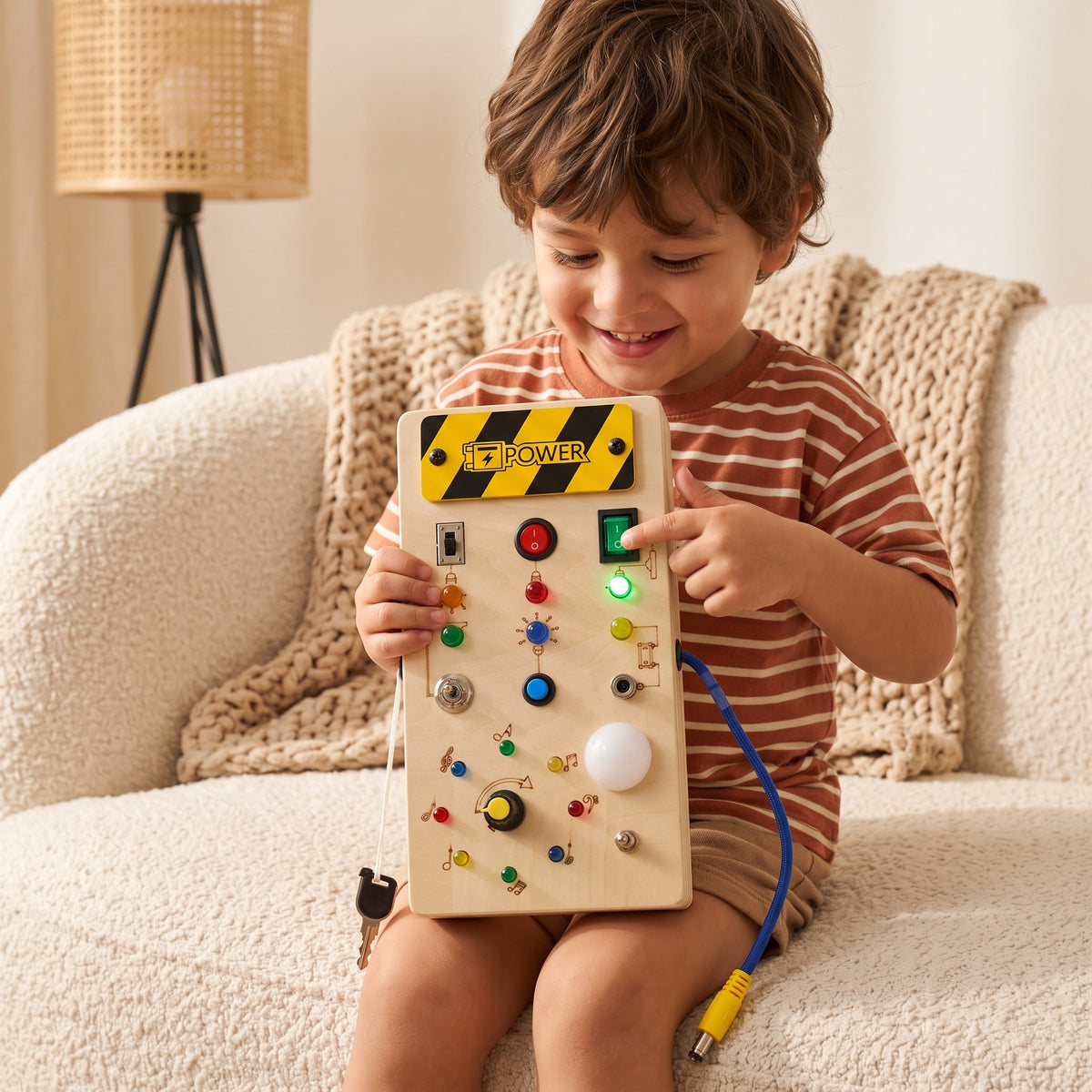 Boy flicking a switch on the Momi Toys Wooden Busy Board
