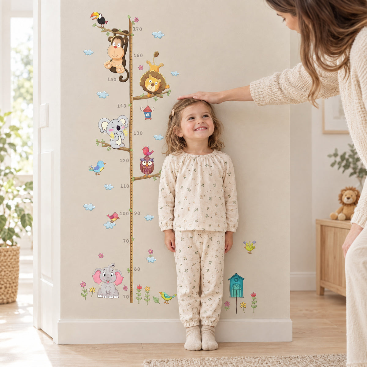 Toddler measured against the Momi Toys jungle height chart